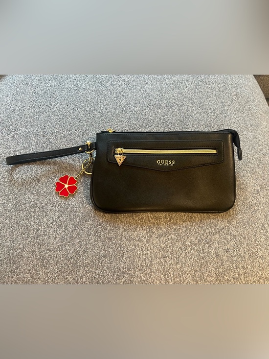 Guess Handbags - GUESS Black Wristlet with Gold Hardware and Red Flower Charm